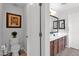 A bathroom with a toilet to the left and double vanities with a mirror on the right at 2950 E Dublin St, Gilbert, AZ 85295