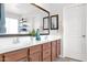 Well-lit bathroom featuring a double vanity with granite countertops and decorative plants for a spa-like feel at 2950 E Dublin St, Gilbert, AZ 85295