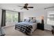 Well-lit bedroom with large windows, neutral colors, and a ceiling fan at 2950 E Dublin St, Gilbert, AZ 85295
