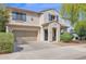 Two-story home featuring a two-car garage and a welcoming front entrance at 2950 E Dublin St, Gilbert, AZ 85295
