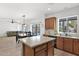 Kitchen opens to dining area, featuring granite counters and wood cabinets at 2950 E Dublin St, Gilbert, AZ 85295