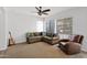 Spacious living room with natural light, comfortable seating, and ceiling fan at 2950 E Dublin St, Gilbert, AZ 85295