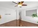 A spacious living room with hardwood floors, natural light, and a ceiling fan at 2950 E Dublin St, Gilbert, AZ 85295