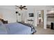 Bright main bedroom with ceiling fan, television, and an ensuite bathroom with wooden accents at 2950 E Dublin St, Gilbert, AZ 85295