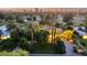 Stunning aerial view of property, showcasing lush landscaping, mature trees, and city skyline at sunset at 3006 N Manor W Dr, Phoenix, AZ 85014