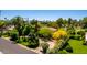Captivating aerial view of a home surrounded by lush greenery, palm trees, and beautiful landscaping at 3006 N Manor W Dr, Phoenix, AZ 85014