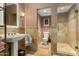 Elegant bathroom featuring a pedestal sink, walk-in shower, and neutral finishes at 3006 N Manor W Dr, Phoenix, AZ 85014