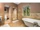 Bathroom featuring a soaking tub, walk-in shower, and natural light at 3006 N Manor W Dr, Phoenix, AZ 85014