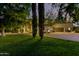 Home exterior featuring manicured lawn, mature trees, and tasteful landscape lighting at 3006 N Manor W Dr, Phoenix, AZ 85014