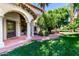Home with arched porch and walkway to the front door surrounded by lush green foliage at 3006 N Manor W Dr, Phoenix, AZ 85014