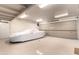 Well-lit garage with epoxy floors, white brick, overhead storage, and a modern roll-up door at 3006 N Manor W Dr, Phoenix, AZ 85014
