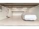 Bright, clean garage with epoxy floors and ample storage space, featuring a car covered up at 3006 N Manor W Dr, Phoenix, AZ 85014