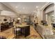 Expansive kitchen with two islands, modern appliances, open layout, and seamless flow to the dining and living areas at 3006 N Manor W Dr, Phoenix, AZ 85014