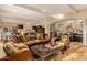 Spacious living room featuring a large leather sofa and an arched opening to the kitchen at 3006 N Manor W Dr, Phoenix, AZ 85014