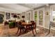 Open-concept living and dining area with built-in bookshelves and access to the outdoor area at 3006 N Manor W Dr, Phoenix, AZ 85014
