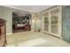Spacious main bedroom with light walls, an arched doorway, and french doors leading to a balcony at 3006 N Manor W Dr, Phoenix, AZ 85014
