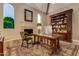 Spacious office with fireplace, beamed ceilings, built-in bookshelf, and custom desk at 3006 N Manor W Dr, Phoenix, AZ 85014