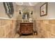 Charming powder room features a vanity with antique vanity, sconces, and stone backsplash at 3006 N Manor W Dr, Phoenix, AZ 85014