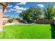 Spacious backyard with lush green synthetic lawn and pool at 3099 E Claxton Ct, Gilbert, AZ 85297
