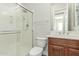 Bright bathroom featuring a shower and wood vanity with double sinks at 3099 E Claxton Ct, Gilbert, AZ 85297