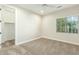 Bright carpeted bedroom with a ceiling fan, large window, and walk-in closet at 3099 E Claxton Ct, Gilbert, AZ 85297