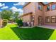 Exterior of home with a patio and well manicured lawn at 3099 E Claxton Ct, Gilbert, AZ 85297