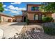 Charming two-story home featuring desert landscaping, a two car garage, and a welcoming covered entryway at 3099 E Claxton Ct, Gilbert, AZ 85297