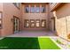Exterior courtyard with manicured grass and many windows at 3099 E Claxton Ct, Gilbert, AZ 85297