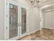 Bright foyer with double glass doors, tile flooring and chandelier at 3099 E Claxton Ct, Gilbert, AZ 85297