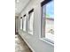 Bright hallway featuring tile flooring, white walls, and windows offering a glimpse of the outdoors at 3099 E Claxton Ct, Gilbert, AZ 85297