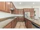 Well-equipped kitchen with stainless steel appliances, granite countertops, gas range, and abundant cabinet space at 3099 E Claxton Ct, Gilbert, AZ 85297
