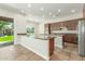 Bright and airy kitchen featuring modern appliances, granite countertops, a large island and tiled floors at 3099 E Claxton Ct, Gilbert, AZ 85297