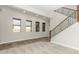 Bright, open living room with large windows and staircase with decorative railings at 3099 E Claxton Ct, Gilbert, AZ 85297