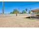 Dirt backyard is surrounded by block fencing with a covered patio and desert landscaping at 3306 W Lupine Ave, Phoenix, AZ 85029