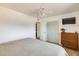 Inviting bedroom features a ceiling fan, closet and TV at 3306 W Lupine Ave, Phoenix, AZ 85029