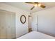 Bright bedroom featuring a ceiling fan, neutral walls and closet for ample storage at 3306 W Lupine Ave, Phoenix, AZ 85029