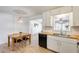 Open dining area with a wooden table set and views into the adjacent kitchen at 3306 W Lupine Ave, Phoenix, AZ 85029