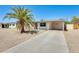 Charming home featuring desert landscaping, covered parking, and a mature palm tree for added curb appeal at 3306 W Lupine Ave, Phoenix, AZ 85029