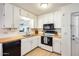 Bright kitchen with white cabinets, butcher block countertops, and a pass-through window at 3306 W Lupine Ave, Phoenix, AZ 85029