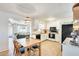 Open concept kitchen with white cabinets, wood countertops, and black appliances adjacent to a dining and living area at 3306 W Lupine Ave, Phoenix, AZ 85029