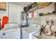 Functional laundry room area with washer, dryer and storage shelves at 3306 W Lupine Ave, Phoenix, AZ 85029