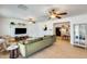 Open-concept living room with a plush green sofa and a glimpse of the kitchen at 3306 W Lupine Ave, Phoenix, AZ 85029