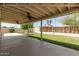Large covered back patio featuring ceiling fans and ample space for outdoor seating at 3732 E Greenway Ln, Phoenix, AZ 85032
