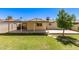 This backyard features a covered patio and a large lawn at 3732 E Greenway Ln, Phoenix, AZ 85032