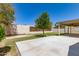 Backyard featuring a covered patio, mature landscaping, and a block fence at 3732 E Greenway Ln, Phoenix, AZ 85032