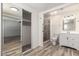 Well-lit bathroom featuring wood-look tile floors, an updated shower, and a toilet at 3732 E Greenway Ln, Phoenix, AZ 85032