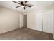 A neutrally colored bedroom with lots of closet space and a ceiling fan at 3732 E Greenway Ln, Phoenix, AZ 85032
