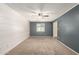 A bedroom with a ceiling fan, window, neutral carpeting, and shiplap accent wall at 3732 E Greenway Ln, Phoenix, AZ 85032