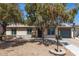 Charming single-story home featuring desert landscaping and a beautiful flowering tree in front at 3732 E Greenway Ln, Phoenix, AZ 85032