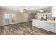 Open floor plan with a modern kitchen featuring stainless steel appliances, white cabinets, and wood flooring at 3732 E Greenway Ln, Phoenix, AZ 85032